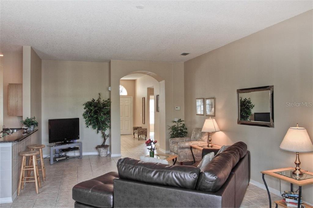 4418 Useppa Drive Bradenton, FL 34203 - Photo 5 of 22 a living room with furniture and a flat screen tv