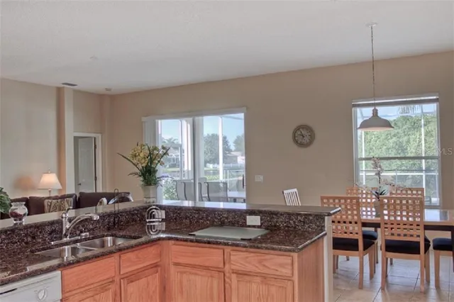 a kitchen with granite countertop a sink and a window