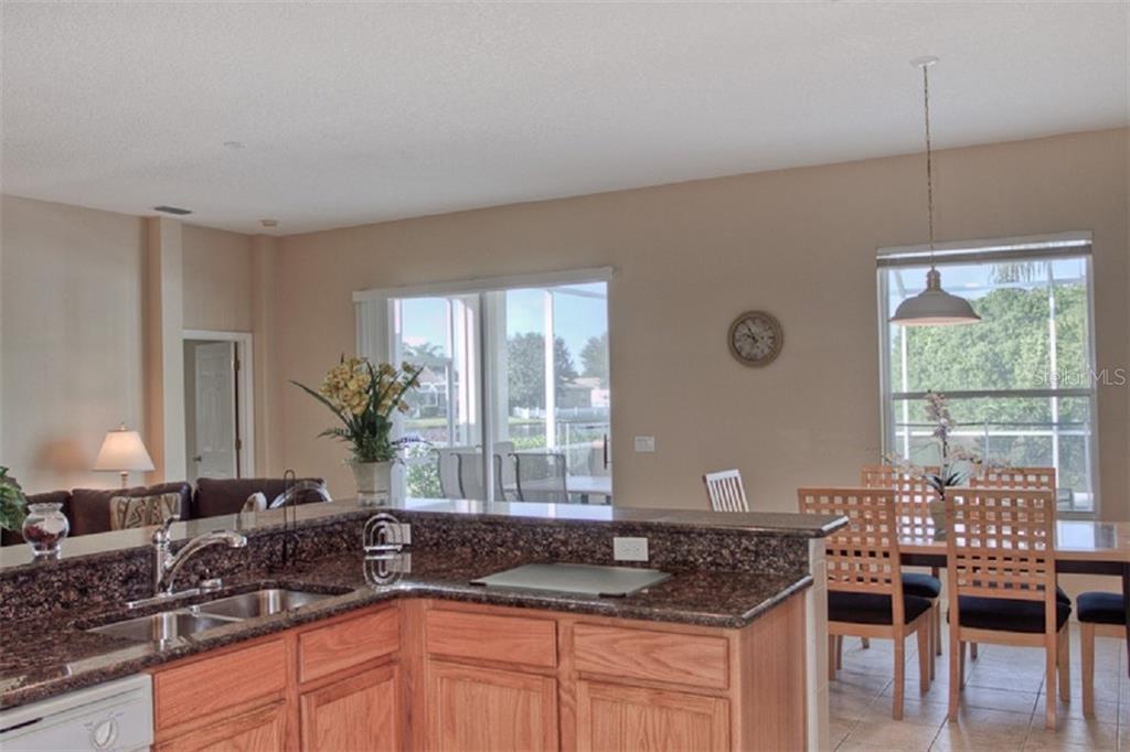 4418 Useppa Drive Bradenton, FL 34203 - Photo 8 of 22 a kitchen with granite countertop a sink and a window