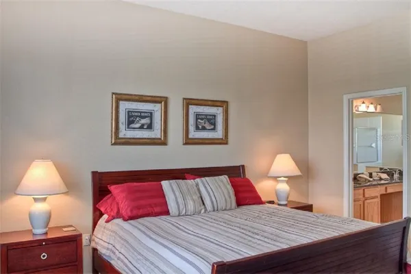 a bedroom with a bed and a lamp