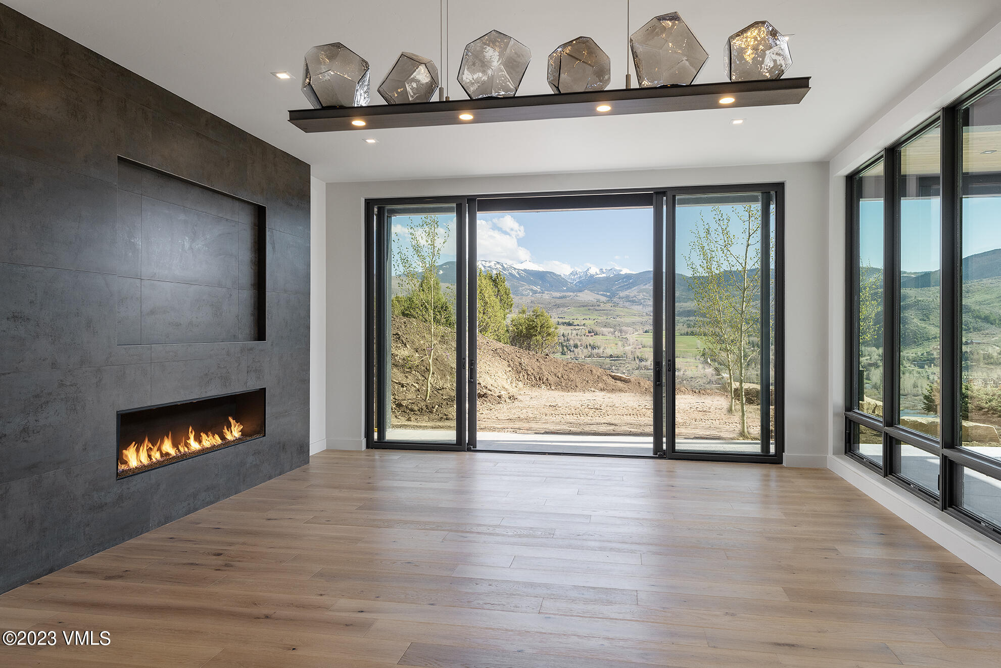 118 Juniper Ridge Road Edwards, CO 81632 - Photo 7 of 16 a view of an empty room with wooden floor and a fireplace