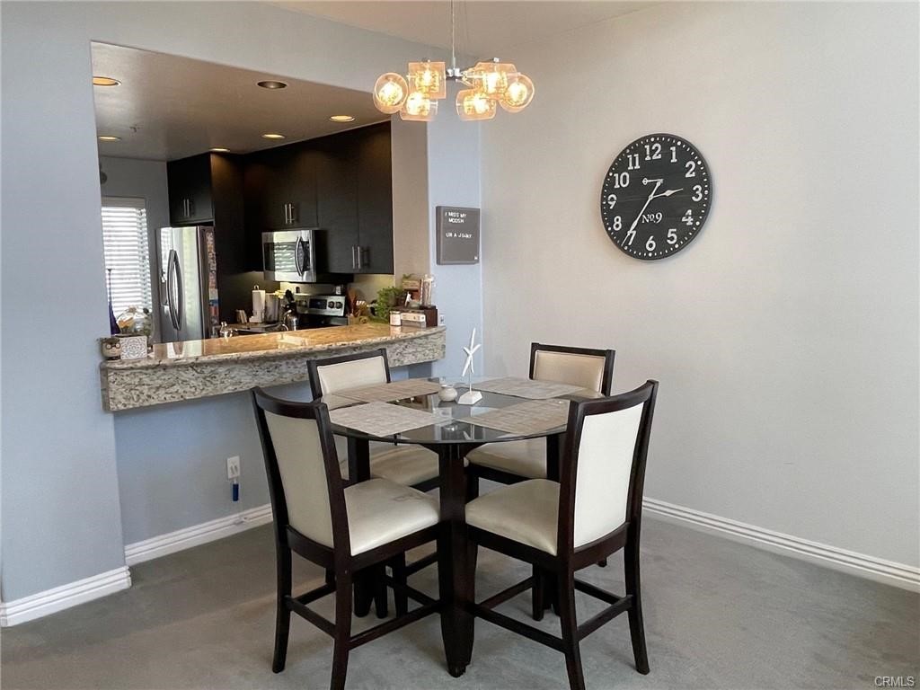 2233 Martin, Unit 413 Irvine, CA 92612 - Photo 21 of 45 a view of a dining room with furniture and a chandelier