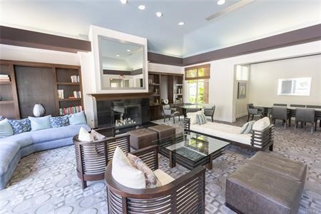 2233 Martin, Unit 413 Irvine, CA 92612 - Photo 41 of 45 a living room with furniture a fireplace and a large window