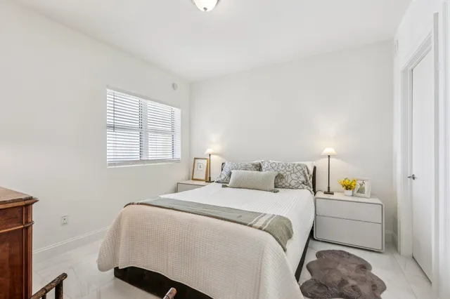 a bedroom with a bed and a night lamp