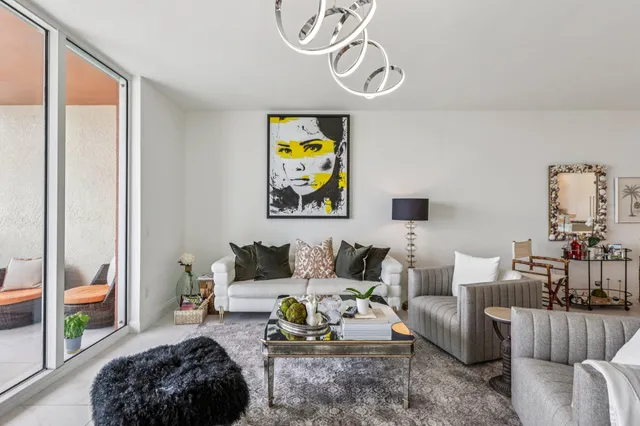 a living room with furniture and a painting on the wall