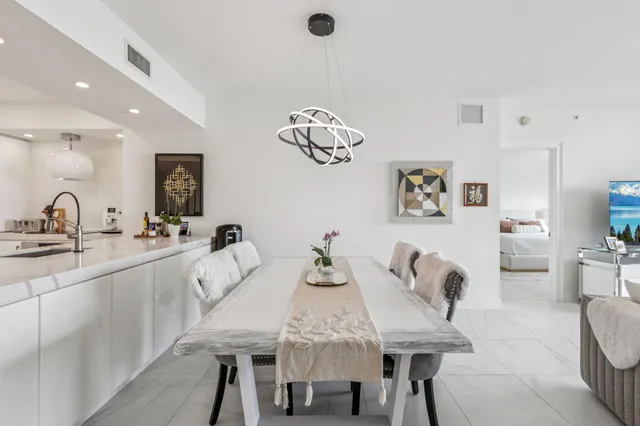 a kitchen with a dining table and chairs