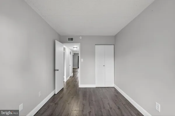 a view of hallway with wooden floor