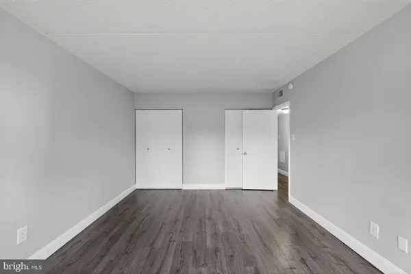 a view of a room with wooden floor
