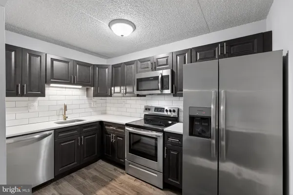 a kitchen with a sink and steel stainless steel appliances