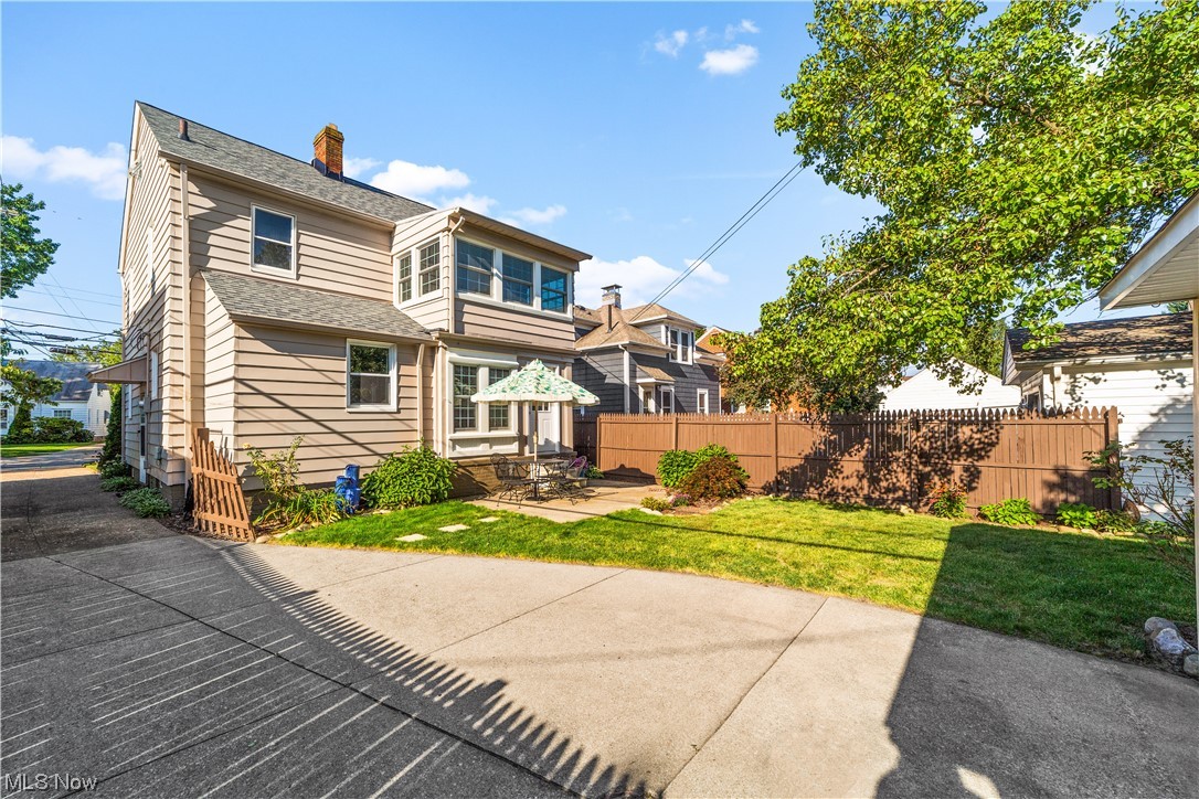 15722 Munn Road Cleveland, OH 44111 - Photo 29 of 32 Back of property with a yard and a patio
