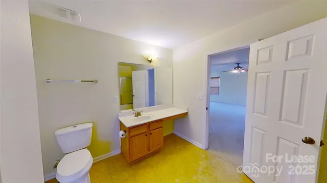 a view of a room with a ceiling fan and a window