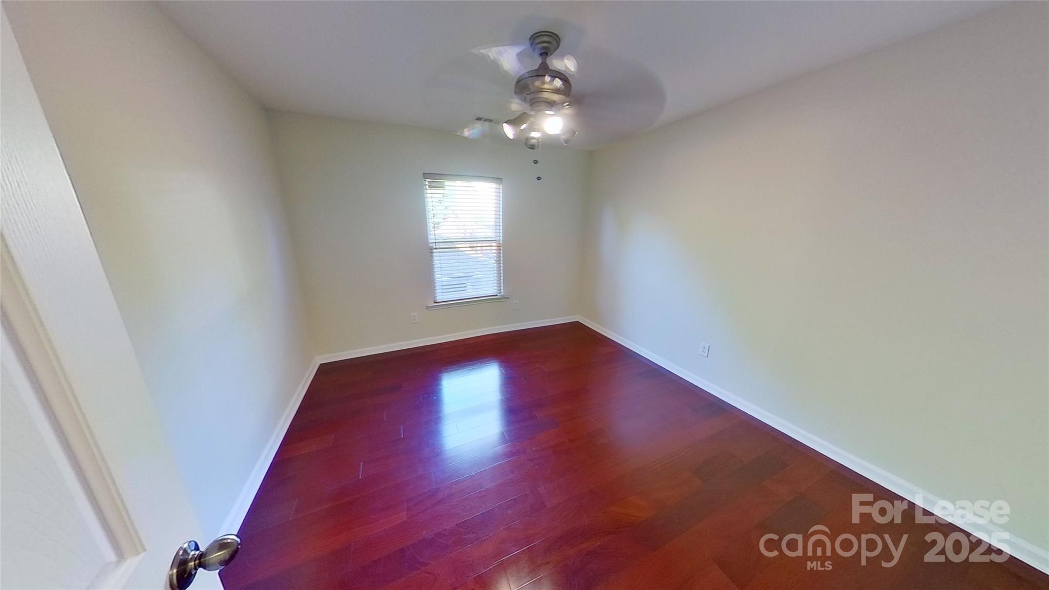 9029 Seamill Road Charlotte, NC 28278 - Photo 6 of 15 a view of an empty room with a window and wooden floor