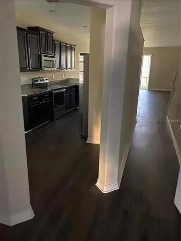 a view of a kitchen from the hallway