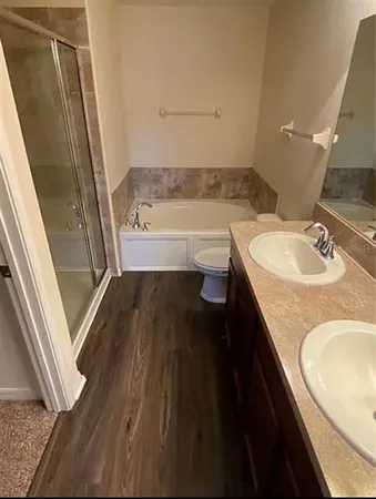 a bathroom with a granite countertop sink toilet and shower
