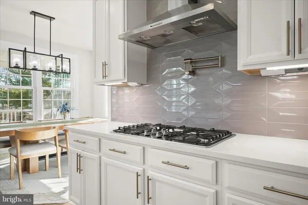 a bedroom with a bed and dresser with mirror