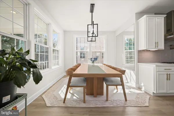 a bathroom with a sink a toilet a mirror and shower