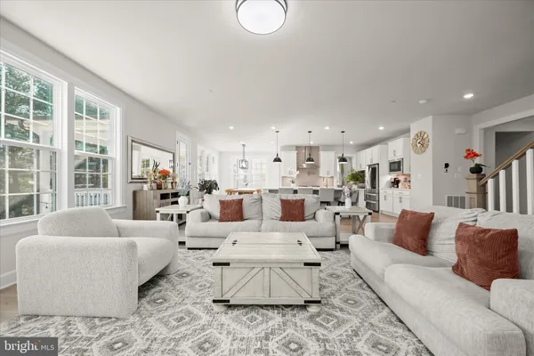 a living room with furniture gym equipment and a window