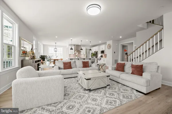 a kitchen with a sink a stove a refrigerator and chairs