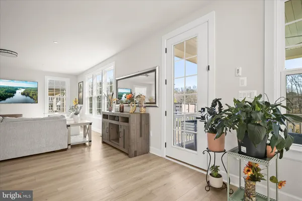 a view of a porch with wooden floor and a floor to ceiling window