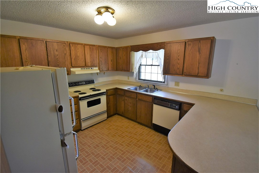 114 Dolinger Road Whitetop, VA 24292 - Photo 12 of 28 a kitchen with a stove a sink and a microwave