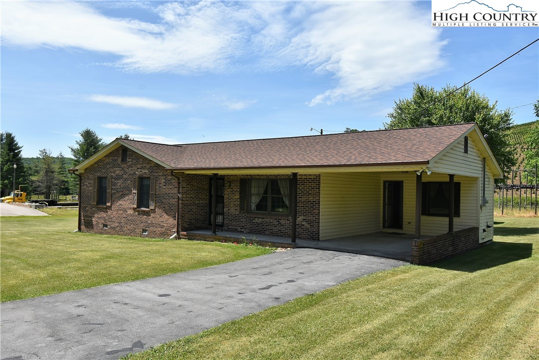 114 Dolinger Road Whitetop, VA 24292 - Photo 2 of 28 a front view of a house with a yard and garage