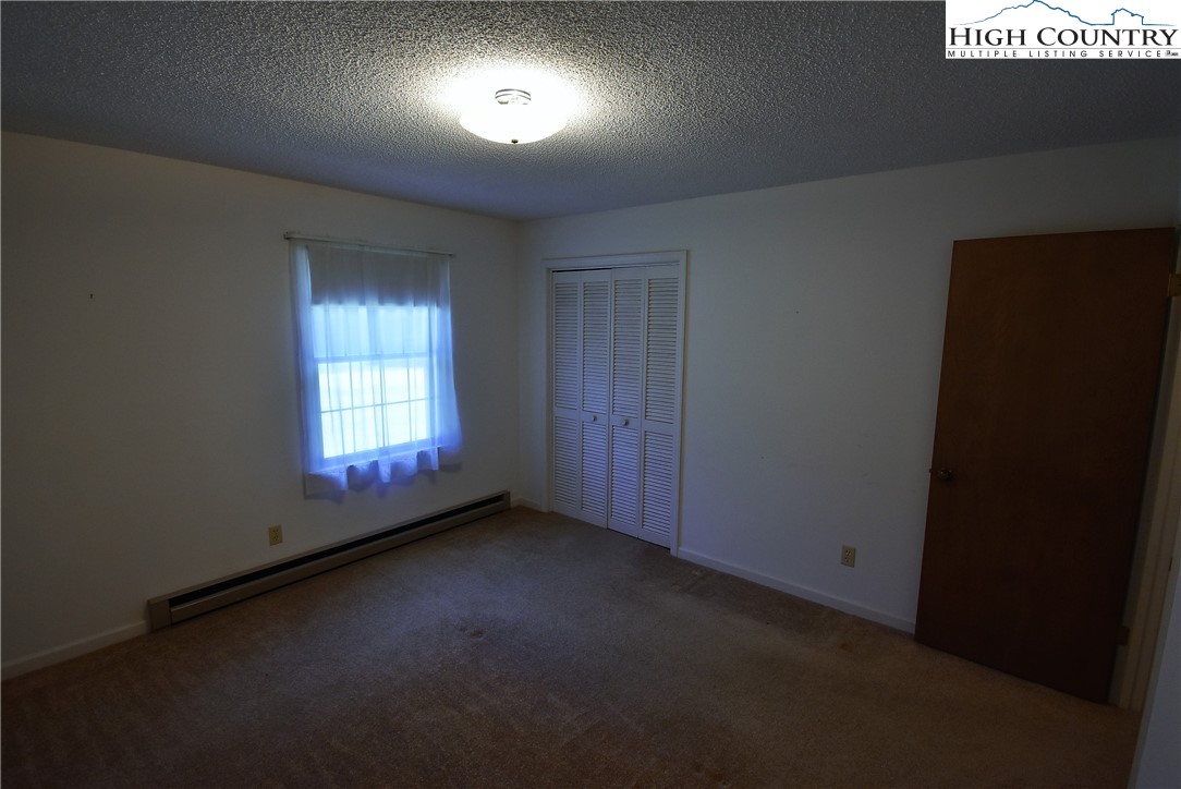 114 Dolinger Road Whitetop, VA 24292 - Photo 22 of 28 an empty room with a empty space and windows