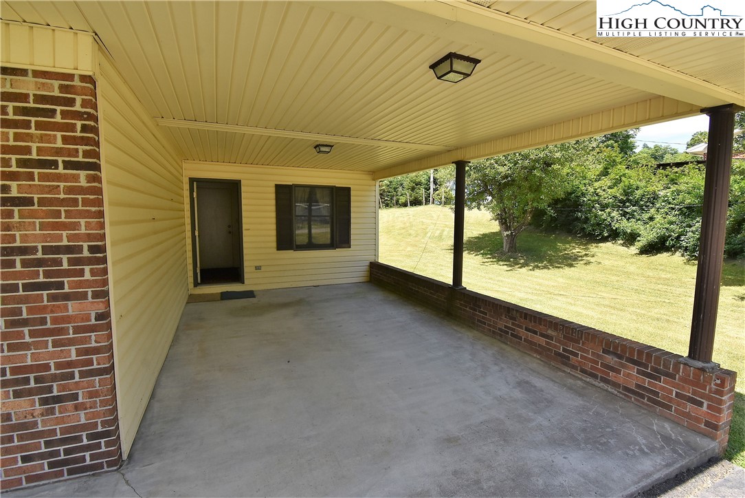 114 Dolinger Road Whitetop, VA 24292 - Photo 5 of 28 a view of a porch with furniture and floor to ceiling window