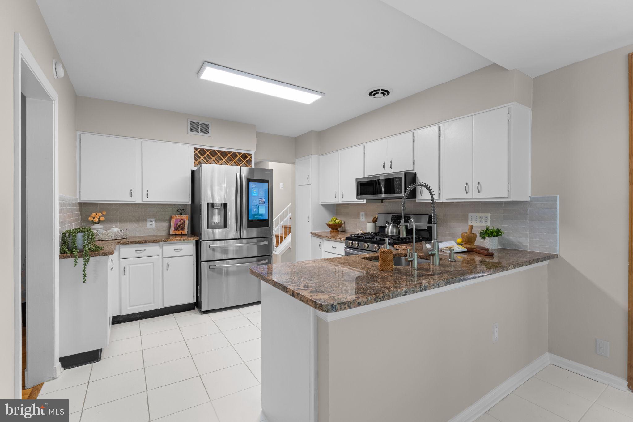 11712 Berwick Road Silver Spring, MD 20904 - Photo 10 of 42 a kitchen with a sink a counter top space cabinets and stainless steel appliances