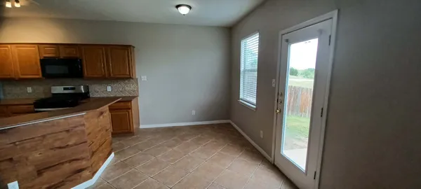 a kitchen with a sink a microwave and cabinets
