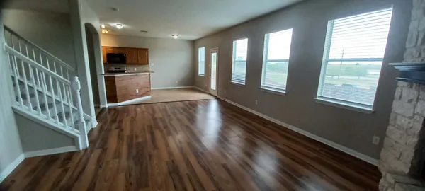a view of a livingroom with wooden floor and a window