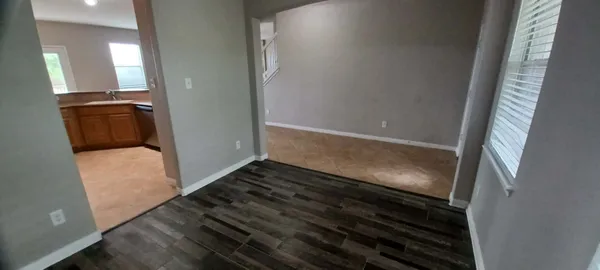 a view of an empty room and wooden floor