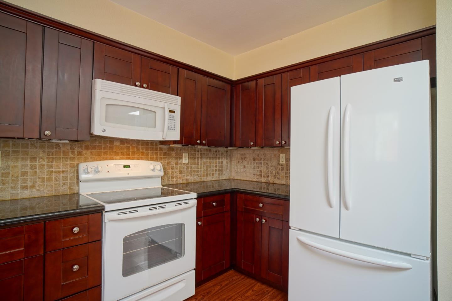 4059 Crest Road Pebble Beach, CA 93953 - Photo 17 of 27 a kitchen with a stove cabinets and refrigerator