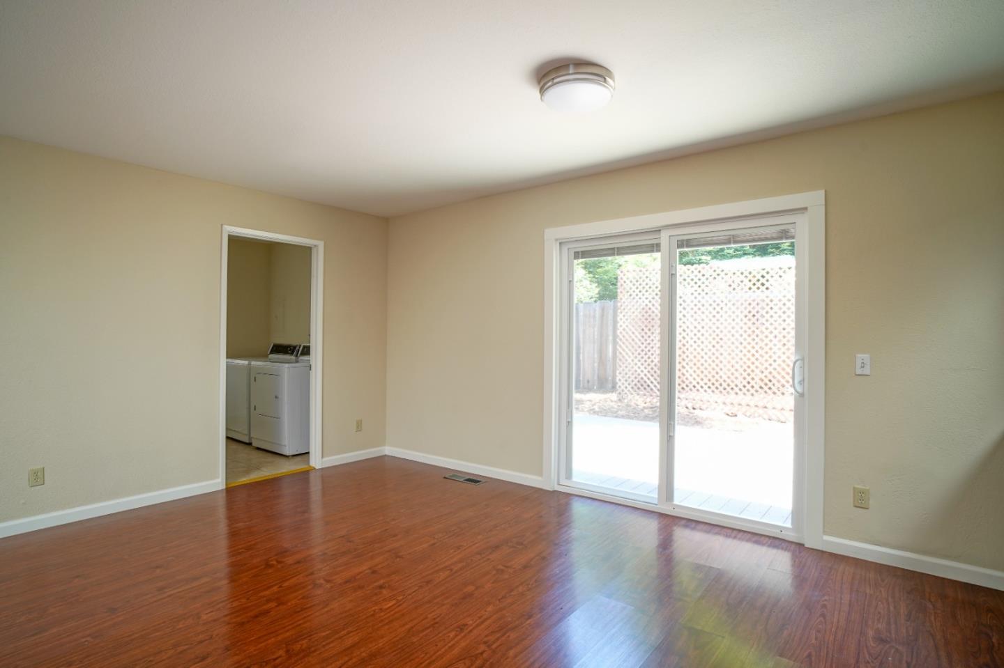 4059 Crest Road Pebble Beach, CA 93953 - Photo 20 of 27 an empty room with wooden floor and windows