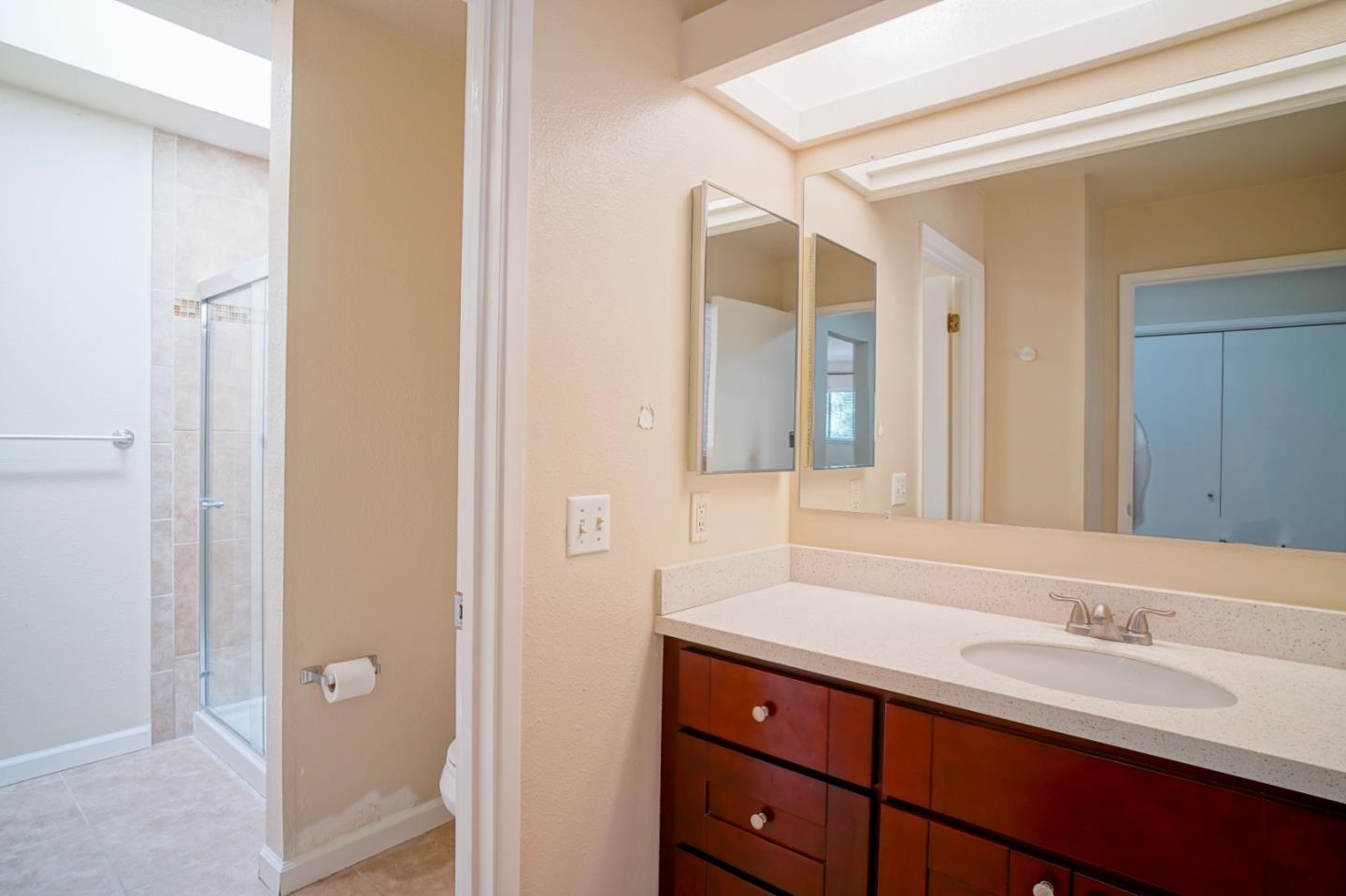 4059 Crest Road Pebble Beach, CA 93953 - Photo 25 of 27 a bathroom with a granite countertop sink and a mirror