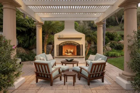a view of a patio with a table and chairs