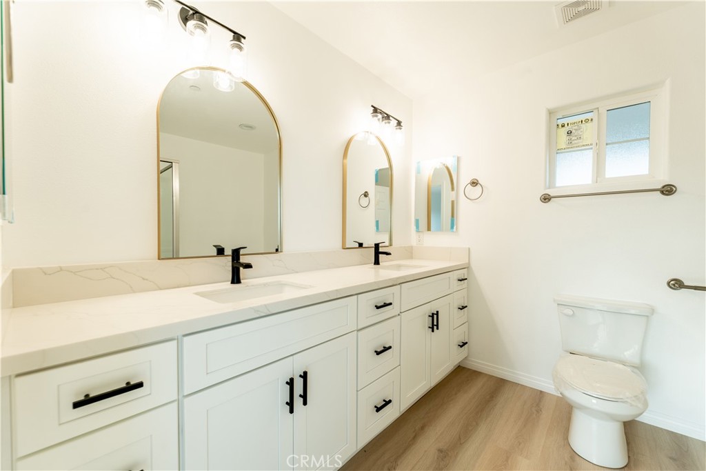16925 Nanticoke Road Apple Valley, CA 92307 - Photo 56 of 87 a bathroom with a double vanity sink and a mirror