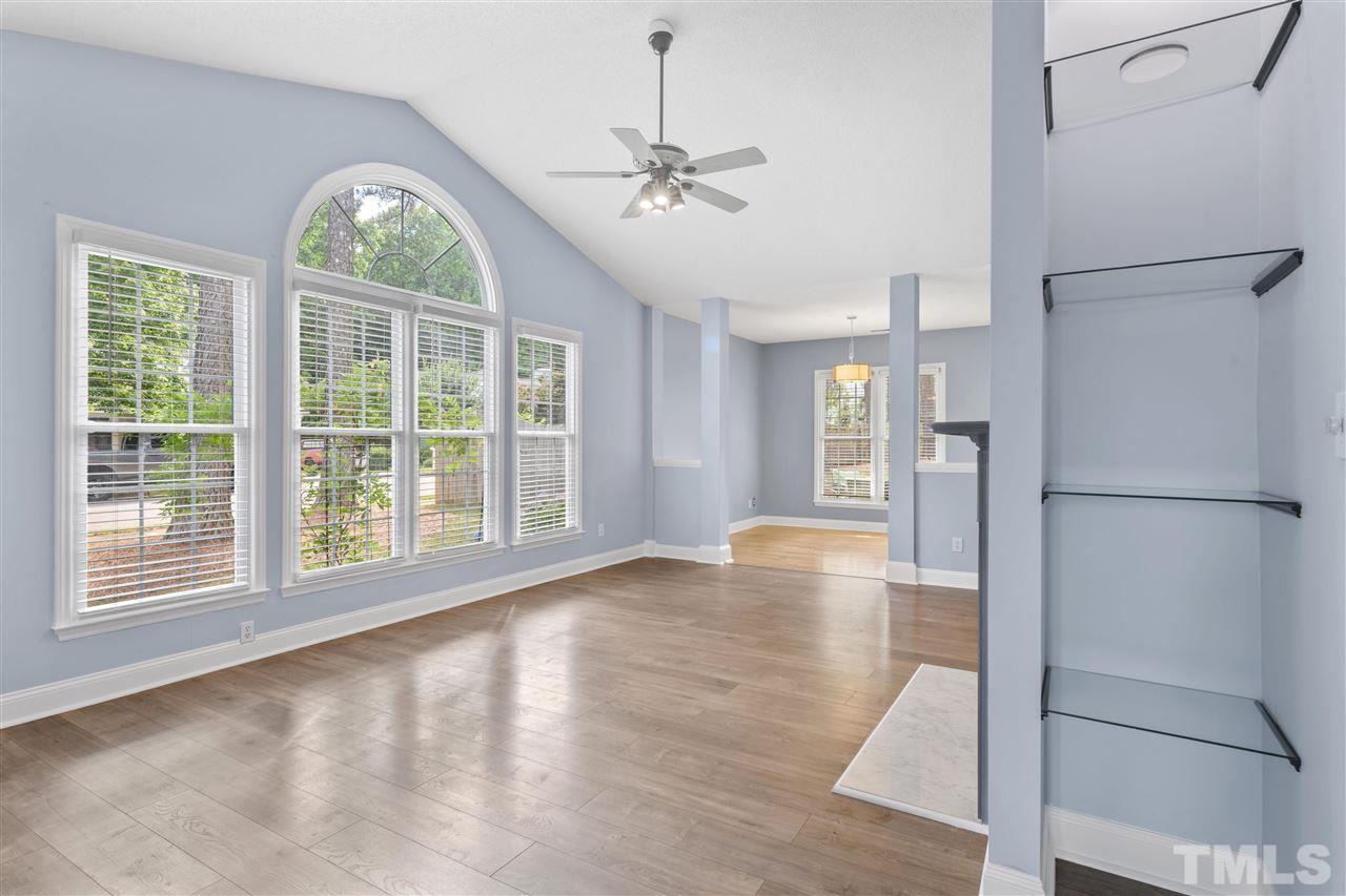 7601 Overland Trail Raleigh, NC 27615 - Photo 5 of 30 Bright & Sunny living room with cathedral ceilings and a wall of windows.