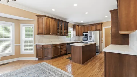 a bathroom with a granite countertop sink a toilet and a mirror