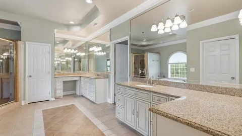 a bathroom with a glass shower door and a window