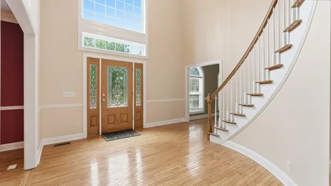 a view of an entryway with wooden floor and door