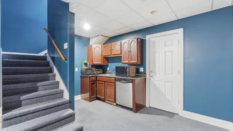 a bathroom with a granite countertop sink a toilet a mirror and shower