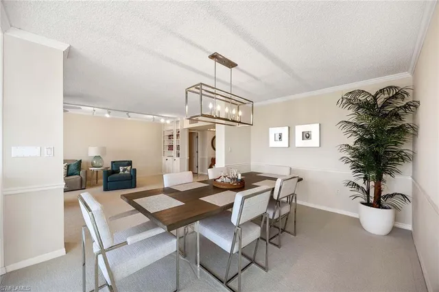 a dining room with furniture and a chandelier