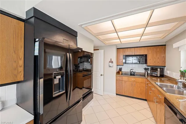 a bedroom with a bed a large window and flat screen television