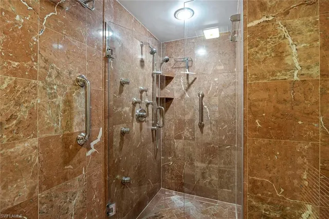 a bathroom with a sink a shower and a mirror