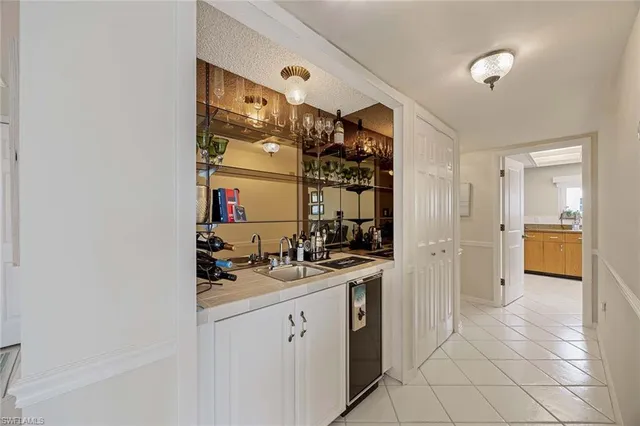 a bedroom with a bed and a flat tv screen on dresser