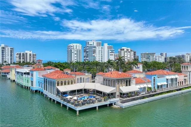 a front view of a multi story building with a yard