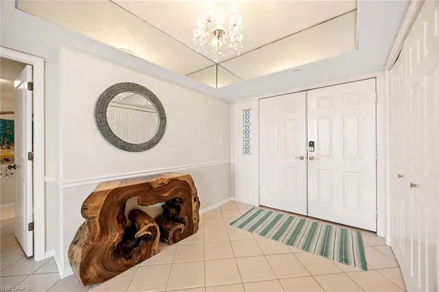 a bedroom with bed and a chandelier