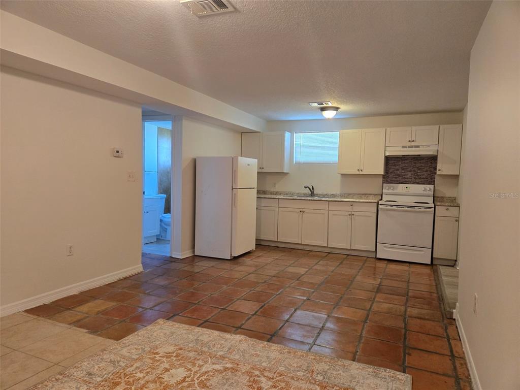 2115 5th Street, Unit 2 Sarasota, FL 34237 - Photo 1 of 22 a kitchen with white cabinets and white appliances