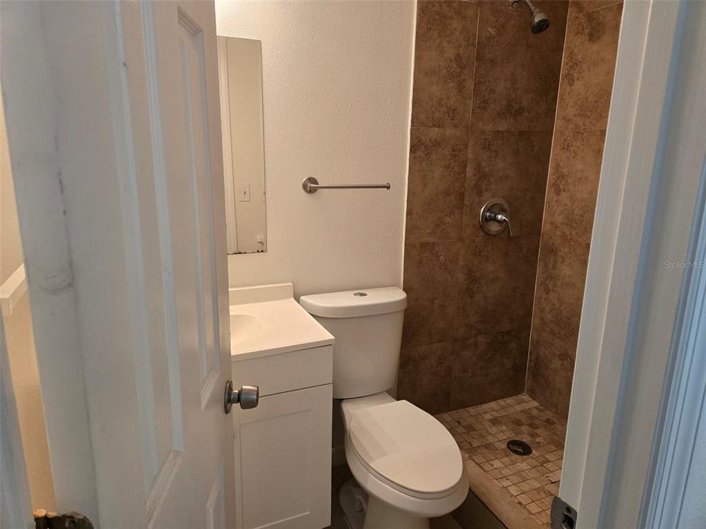 2115 5th Street, Unit 2 Sarasota, FL 34237 - Photo 13 of 22 a white toilet sitting next to a bathroom sink