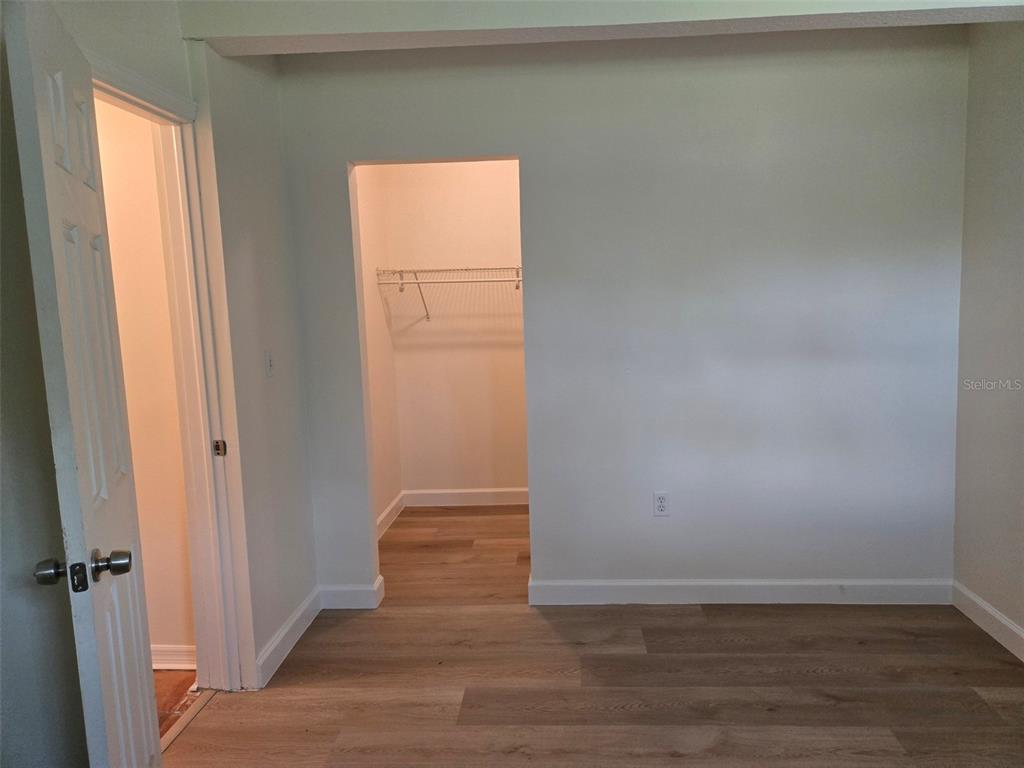 2115 5th Street, Unit 2 Sarasota, FL 34237 - Photo 16 of 22 a view of an empty room and wooden floor and a window